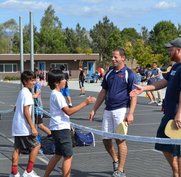 principal and students shaking hands